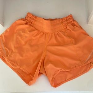 Lululemon shorts. Size 0 4 inches. Color orange. Small stain on back of shorts